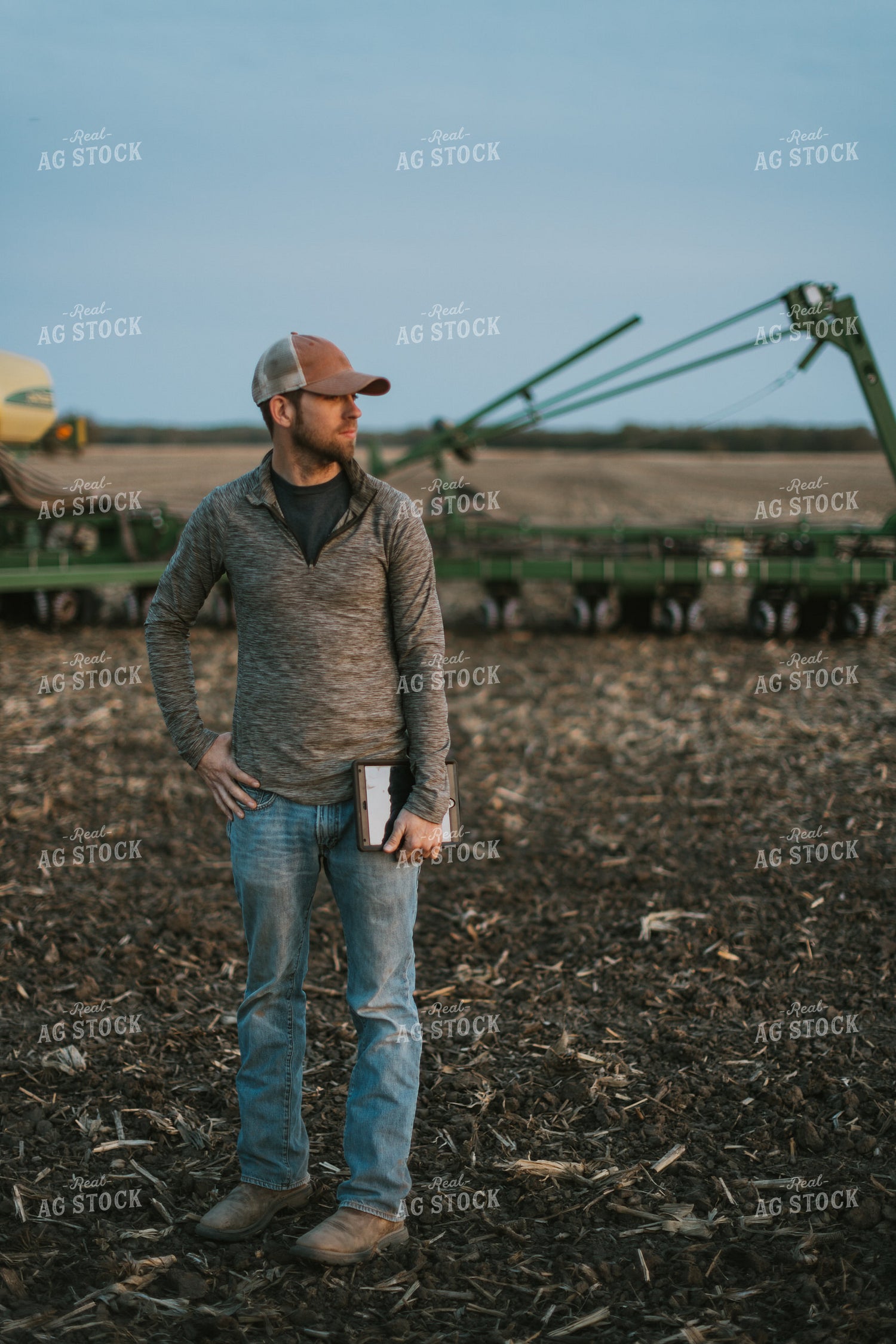 Farmer using Tablet in Field by Planter 8257