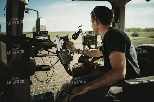 Farmer Adjusting Planter Monitor 4113