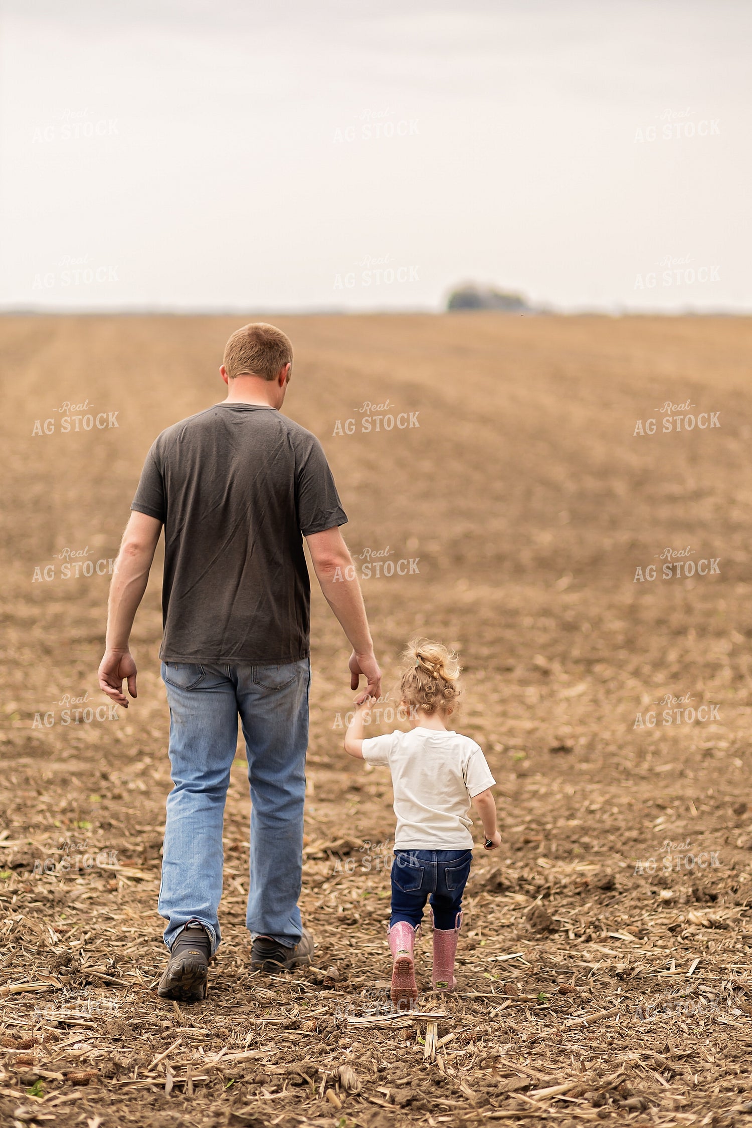 Farmer and Daughter Walking in Field 93290