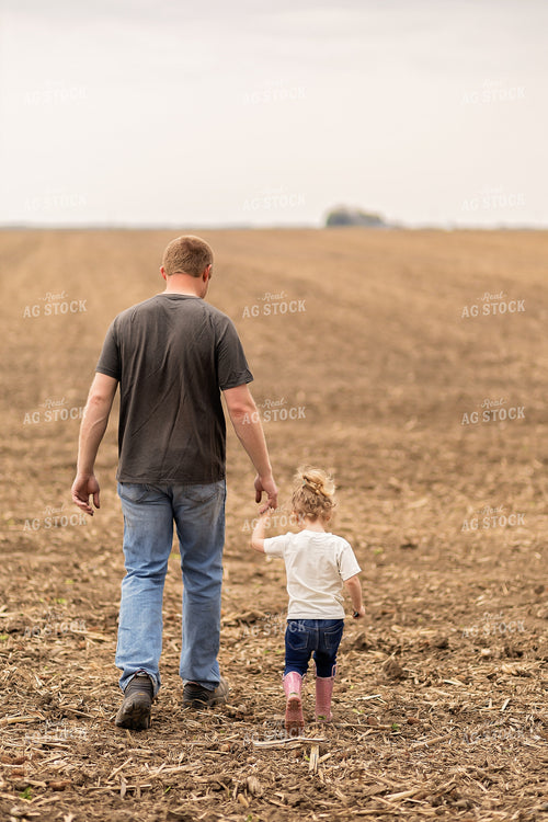 Farmer and Daughter Walking in Field 93290