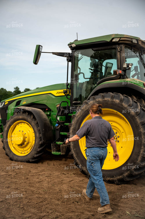 Female Farmer Climbing into Planter 115651