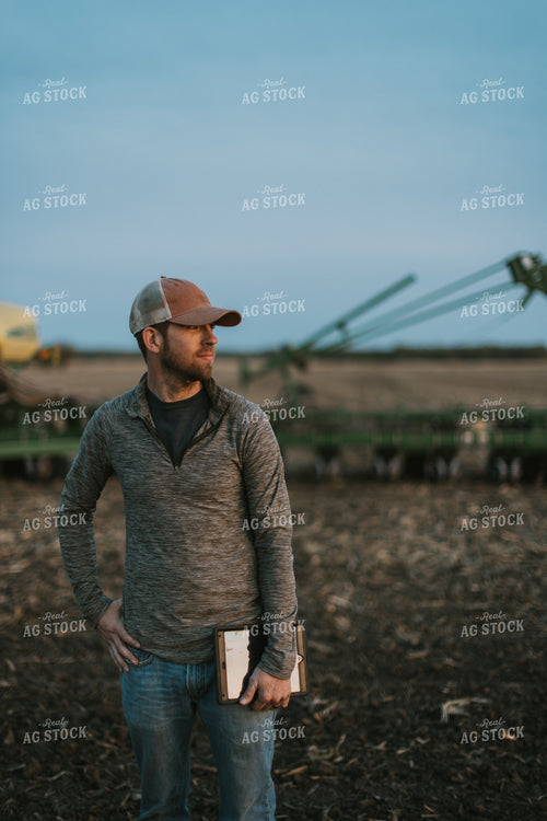 Farmer using Tablet in Field by Planter 8256