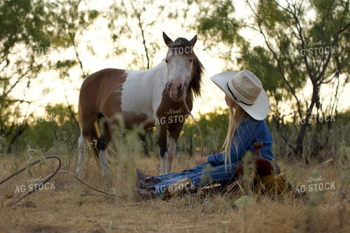 Young Cowgirl Sitting with Horse 205056