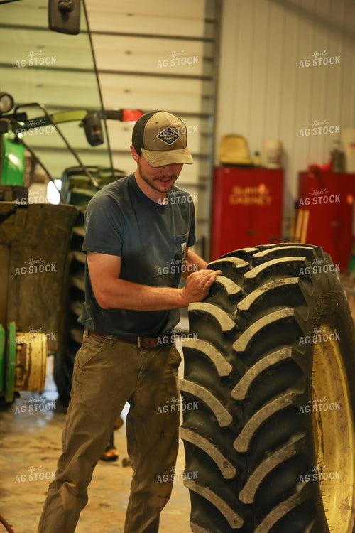 Farmer with Tire in Shed 52439