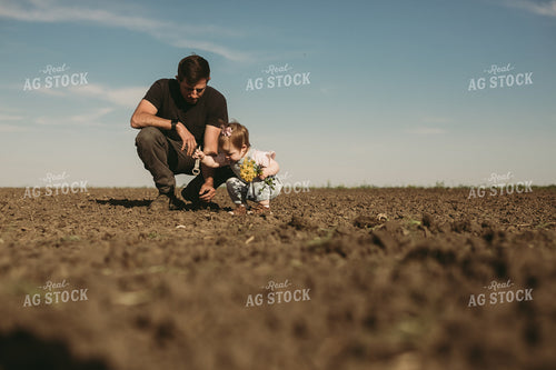 Farmer and Daughter Checking Seed Depth 4175