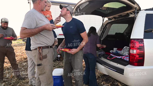 Family Enjoying Harvest Meal in the Field - 546
