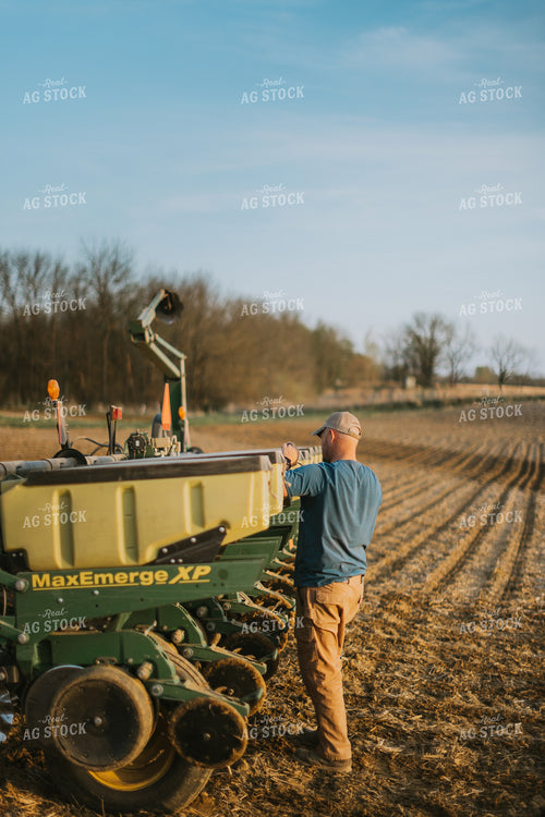Farmer Checking Seed Box on Planter 7448