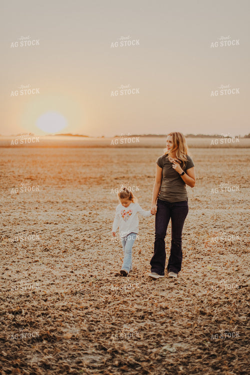 Farm Wife Walking with Daugher in Field 9272