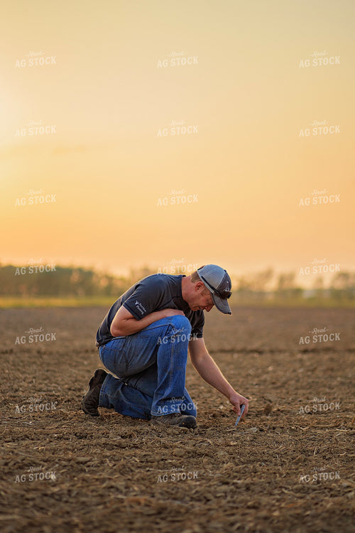 Farmer Checks Seed Depth After Planting 93198