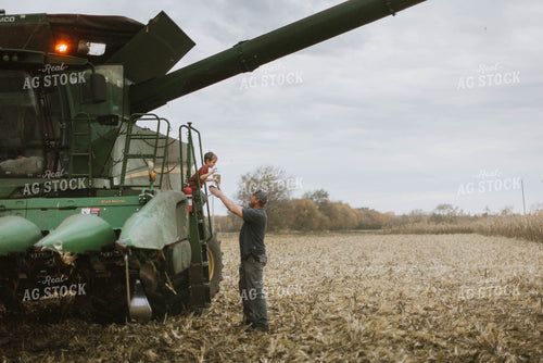Farmer and Son Cimbing into Combine 8604