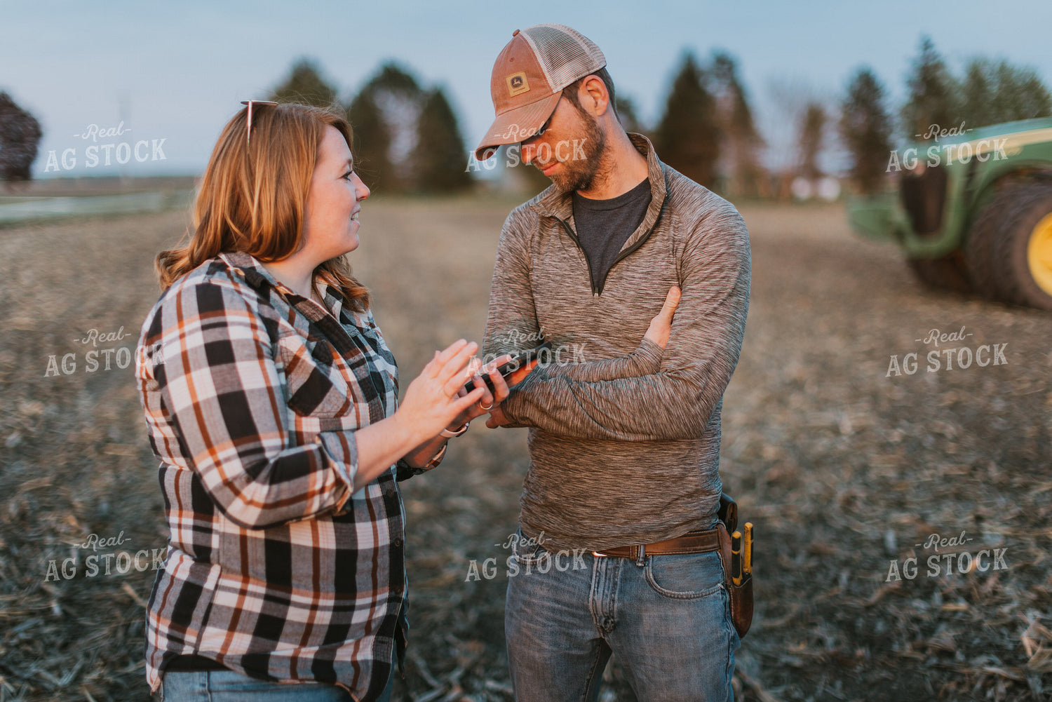 Farmers using Phone in Field by Planter 8250