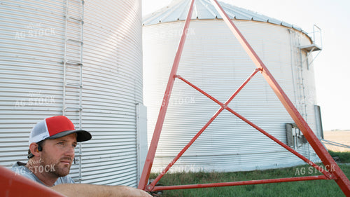 Farmer Leaning on Auger 26083