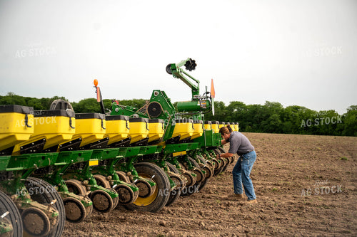 Female Farmer Adjusting by Planter 115657