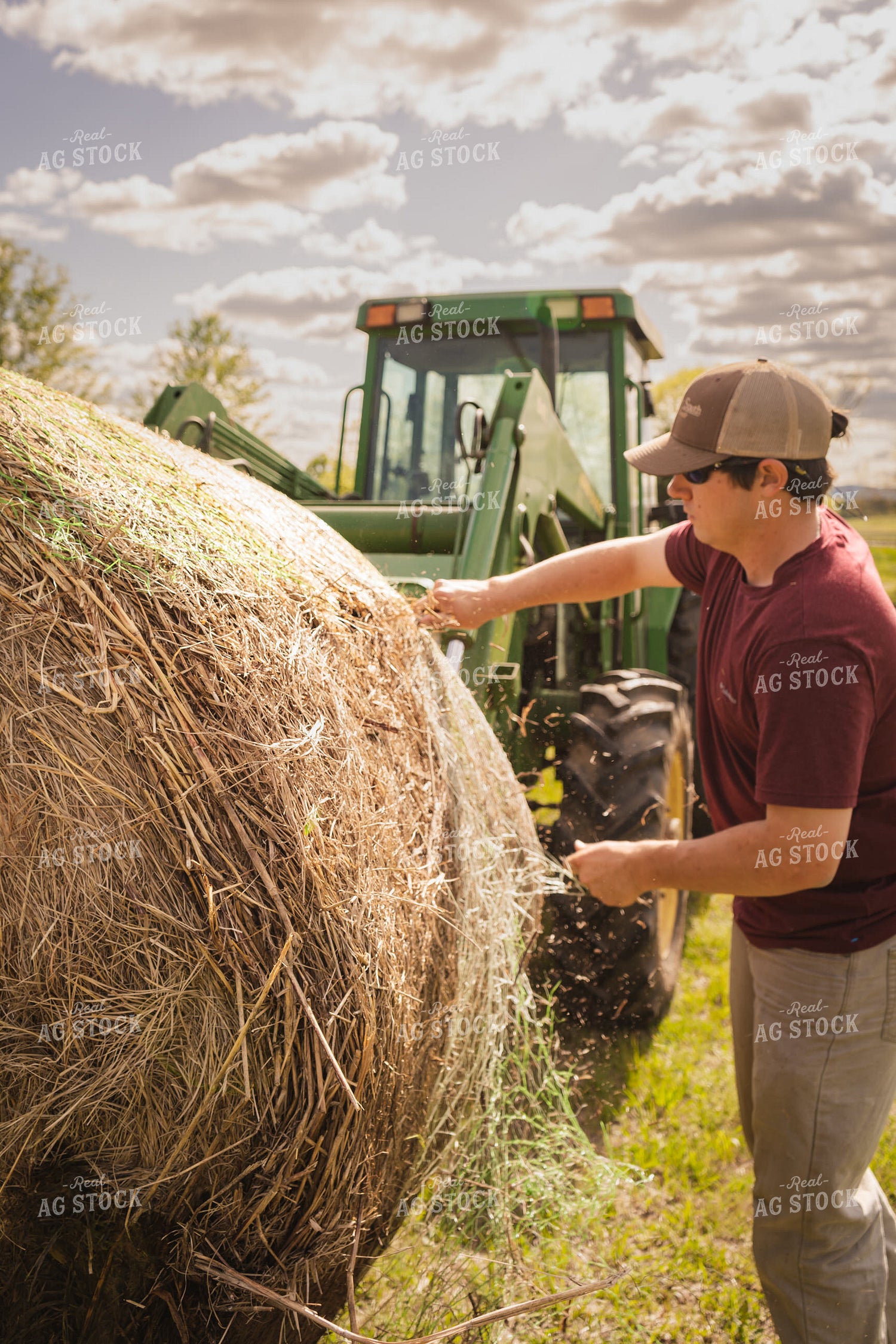 Farmer Unwrapping Hay Bales 128016
