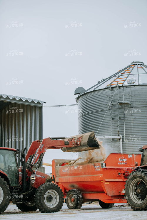 Tractor Emptying into feed mixer 77142