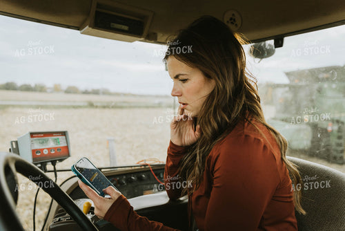 Female Farmer Using Phone in Tractor 8543