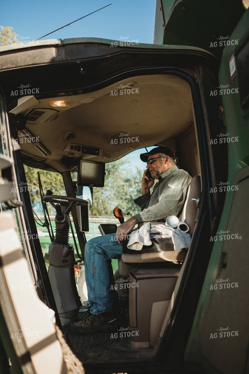 Farmer Talking on Phone in Combine Cab 5226