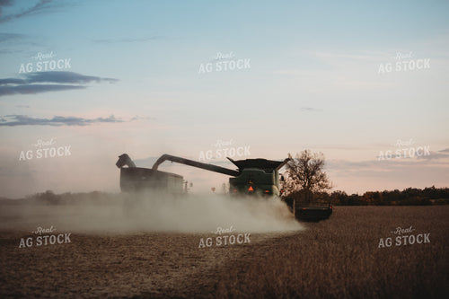 Combine Unloading on the go into Grain Cart at Dusk 3483