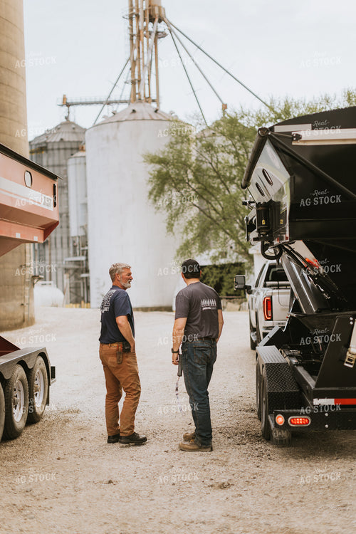 Farmers Talk in Front of Grain Bins 7595