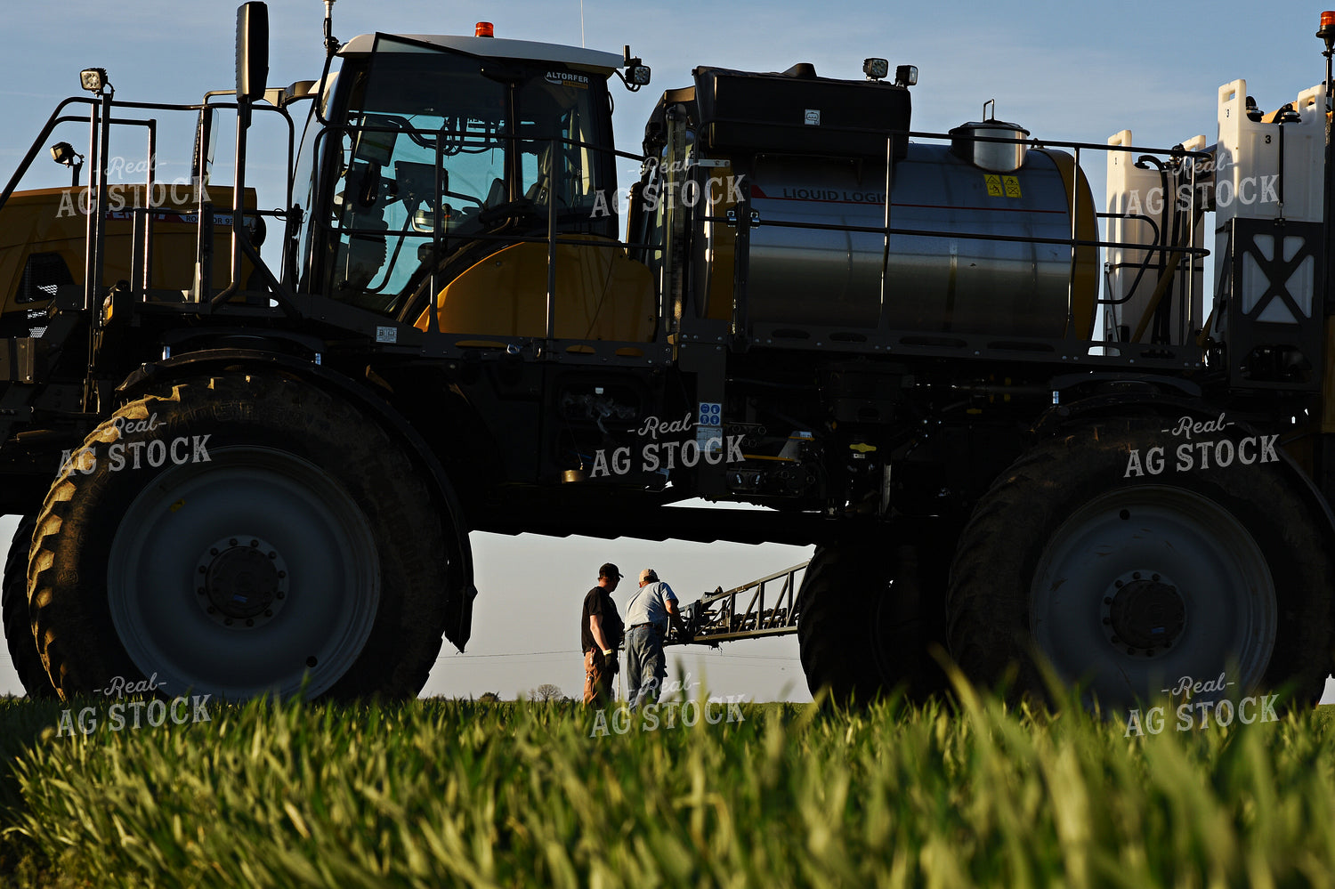 Farmer by Sprayer in Wheat Field 100021
