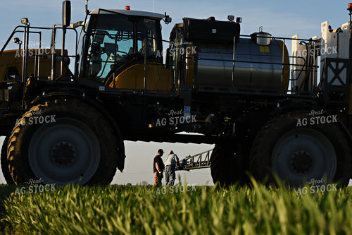 Farmer by Sprayer in Wheat Field 100021