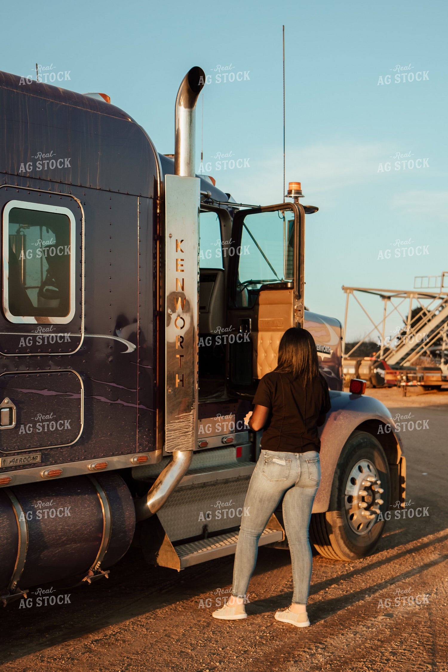 Female Farmer Climbing into Semi 67576