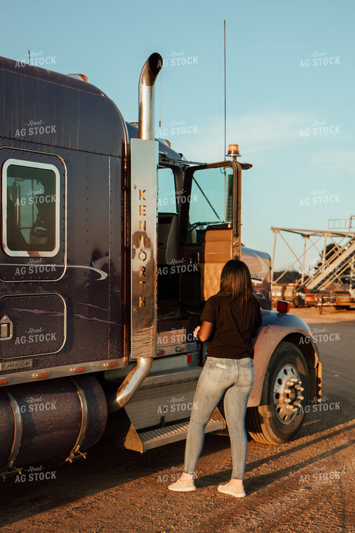 Female Farmer Climbing into Semi 67576