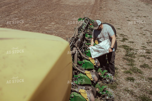 Farmer Filling Planter for Test Plot 196077