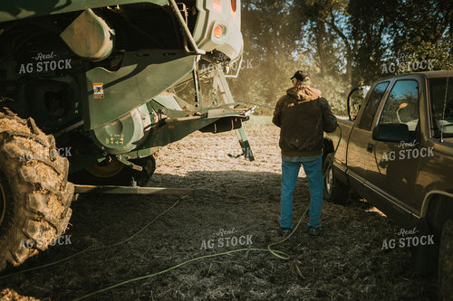 Farmer Using Air Hose to Clean Combine During Soybean Harvest 5200