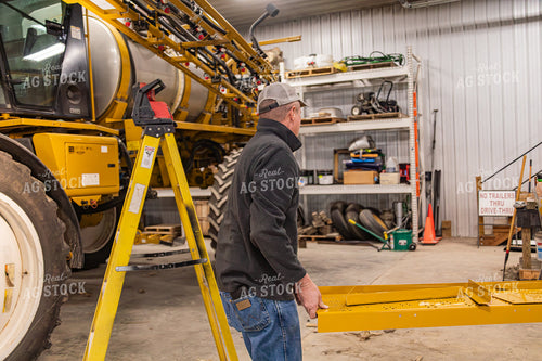 Farmer Fixing Self-Propelled Sprayer 231122