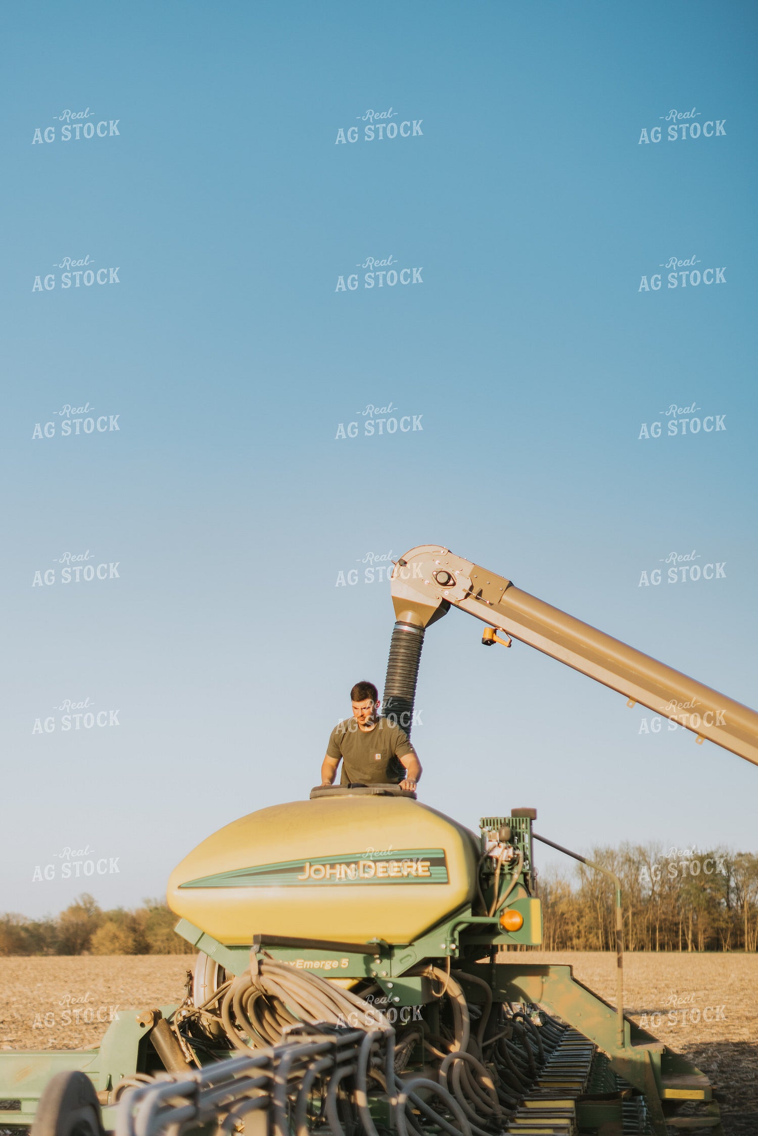 Farmer Fills Planter with Seed Tender in Field 7697