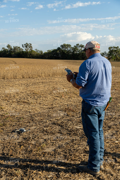 Farmer Flying Drone in Field 65088