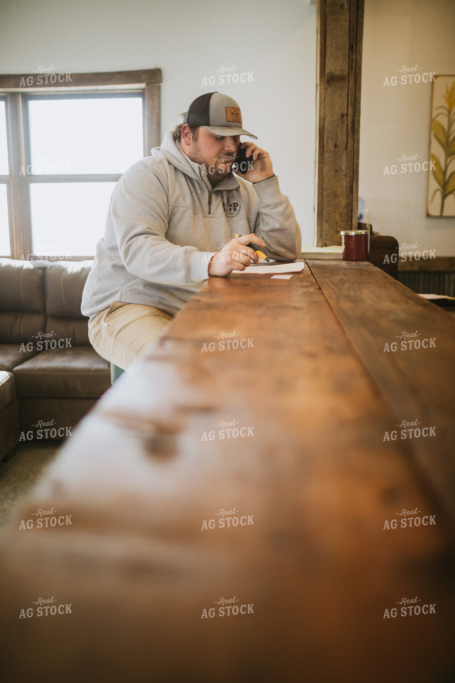 Man Going Over Paperwork and Talking on Phone 5301