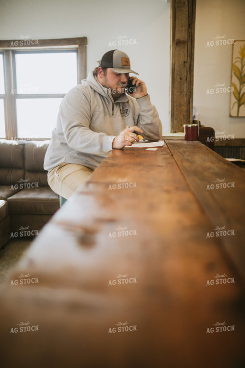 Man Going Over Paperwork and Talking on Phone 5301