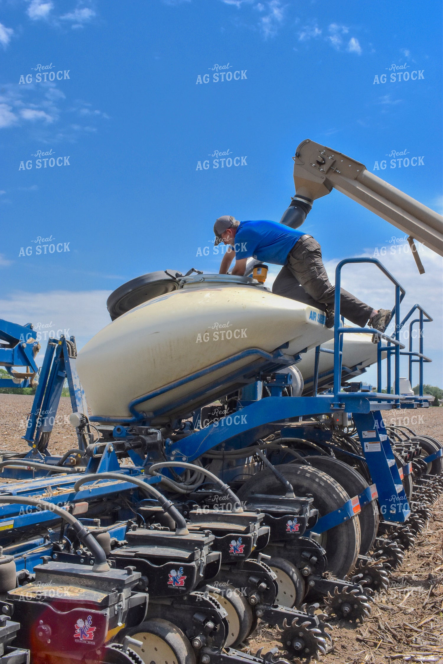 Farmer Checking Bulk Fill Planter 84077