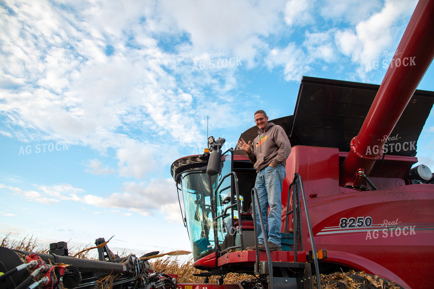 Farmer Climbing into Combine Cab and Waving 25578