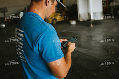 Farmer on Phone in Farm Shop 6204