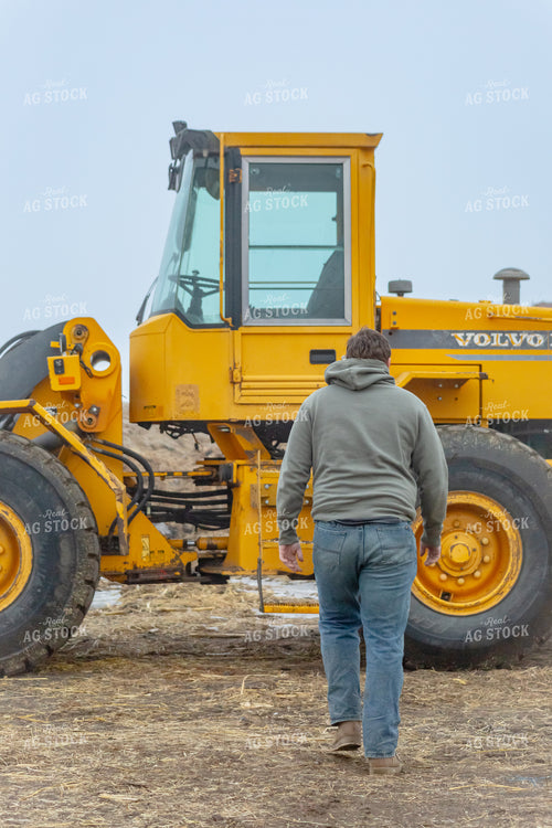 Rancher Walking to Equipment 155346