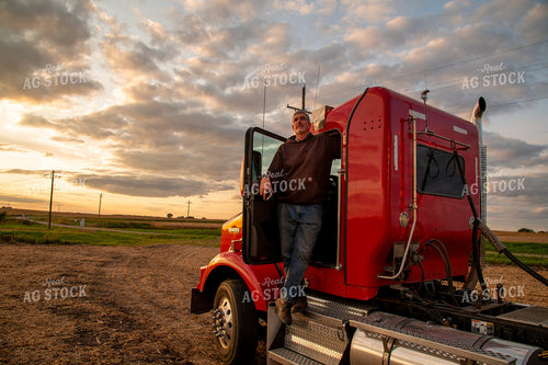 Farmer Watching Harvest from Semi Cab 25697