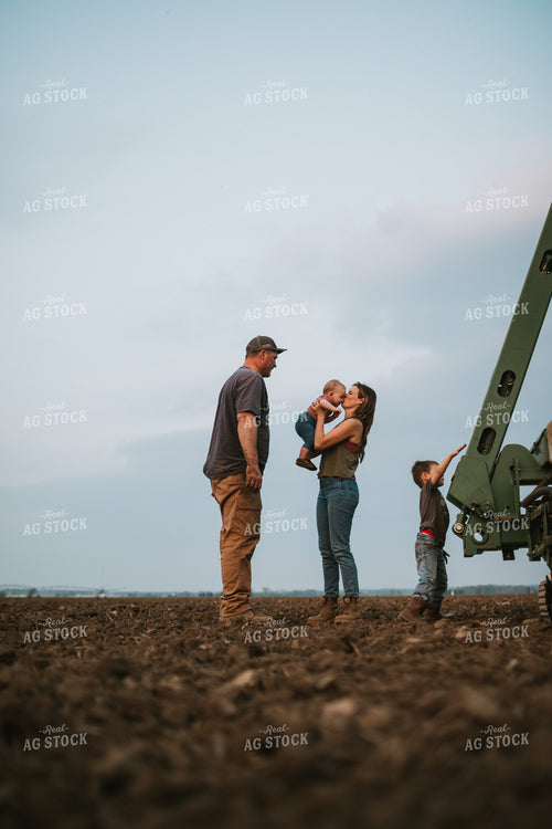 Farm Family in Field During Planting 5727