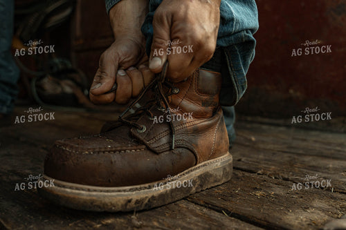 Farmer Tying Boots 58320