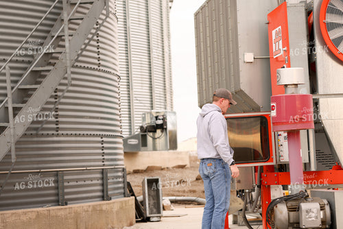 Farmer Checking Grain Dryer 161131