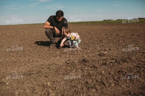 Farmer and Daughter Checking Seed Depth 4174