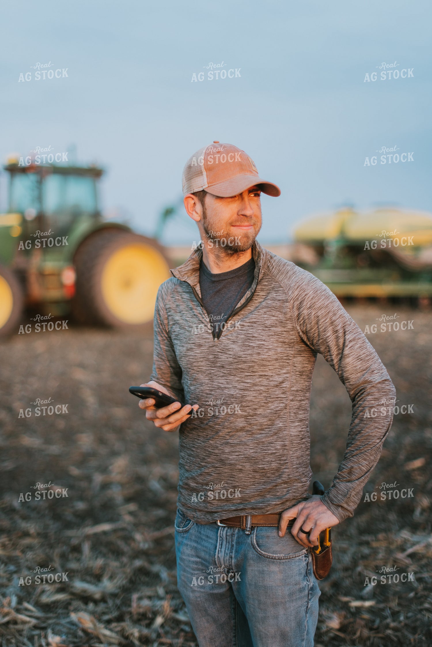 Farmer using Phone in Field by Planter 8249