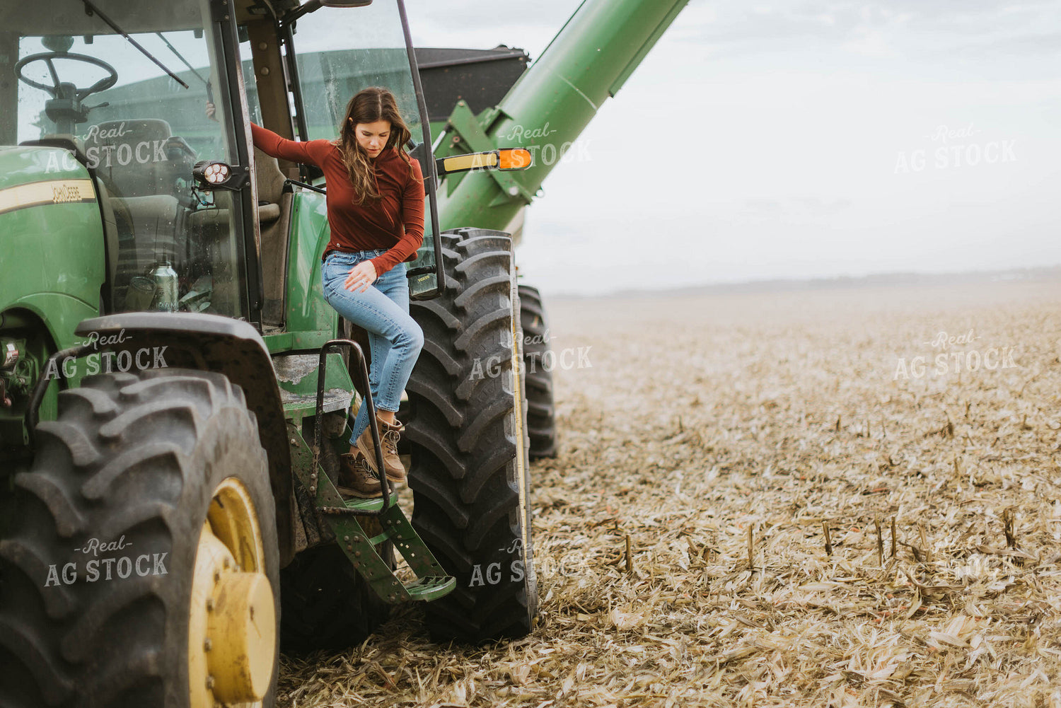Female Farmer Cimbing into Tractor 8555