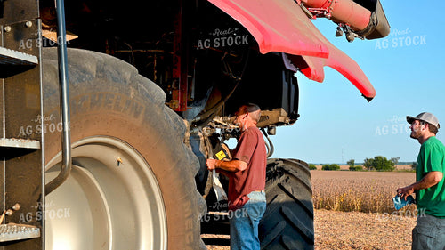 Multigenerational Farm Familiy Repairing Combine in a Bean Field 25519