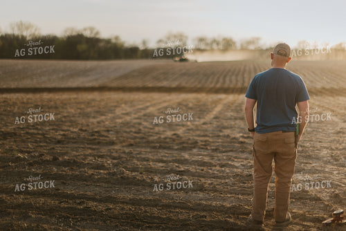 Farmer Standing in Field Watching Platner 7431