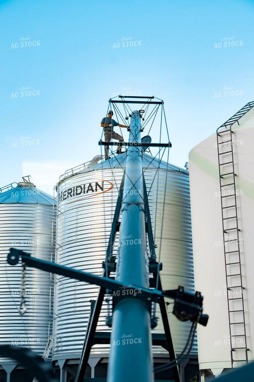 Farmer Lining Up Auger on Bin 187251