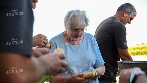 Family Shucking Sweet Corn 25243