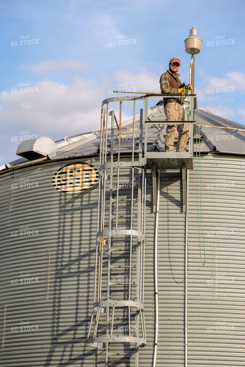Farmer on Top of Grain Bin 52467